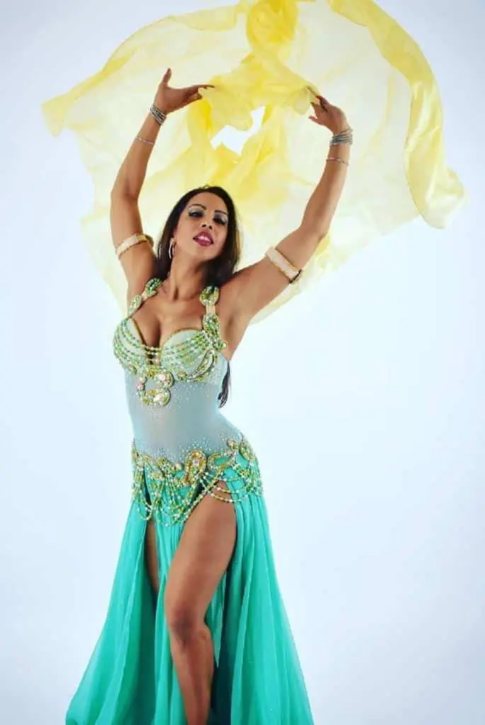 Belly dancer D in a turquoise costume with a yellow silk veil