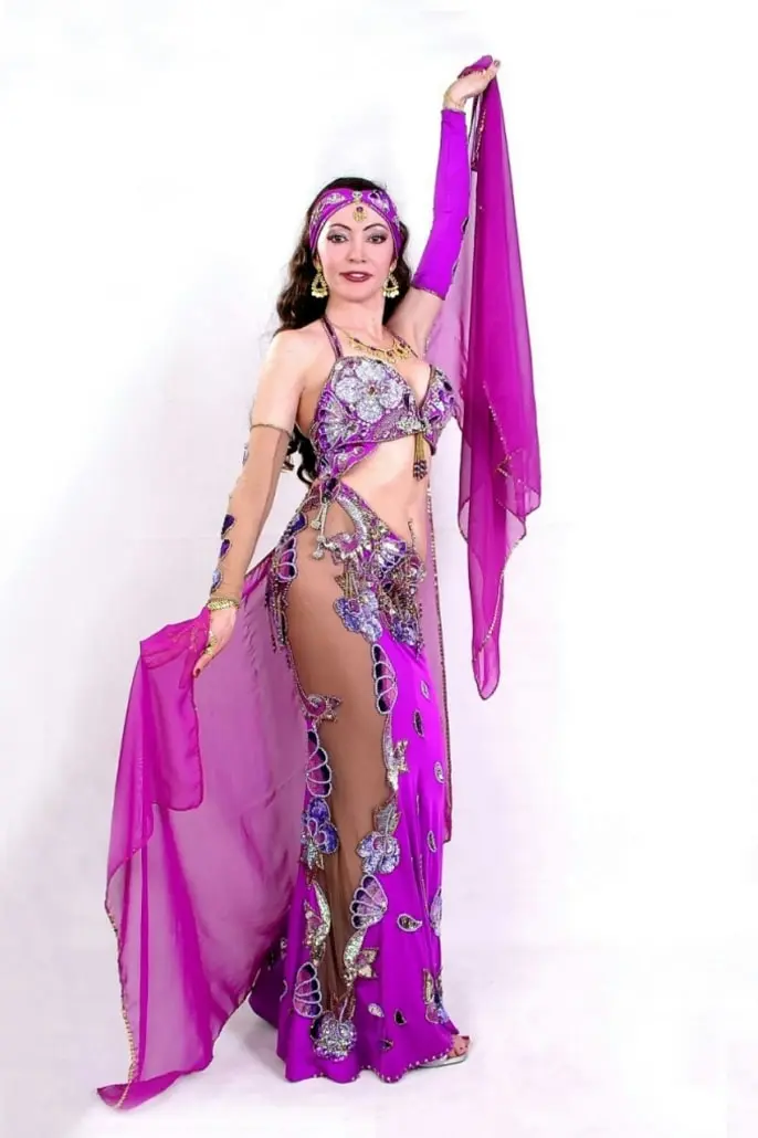 Belly dancer M in a purple costume holding a long silk veil