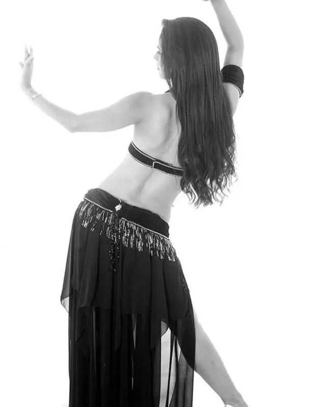 Belly dancer R in a black costume, black and white studio photo