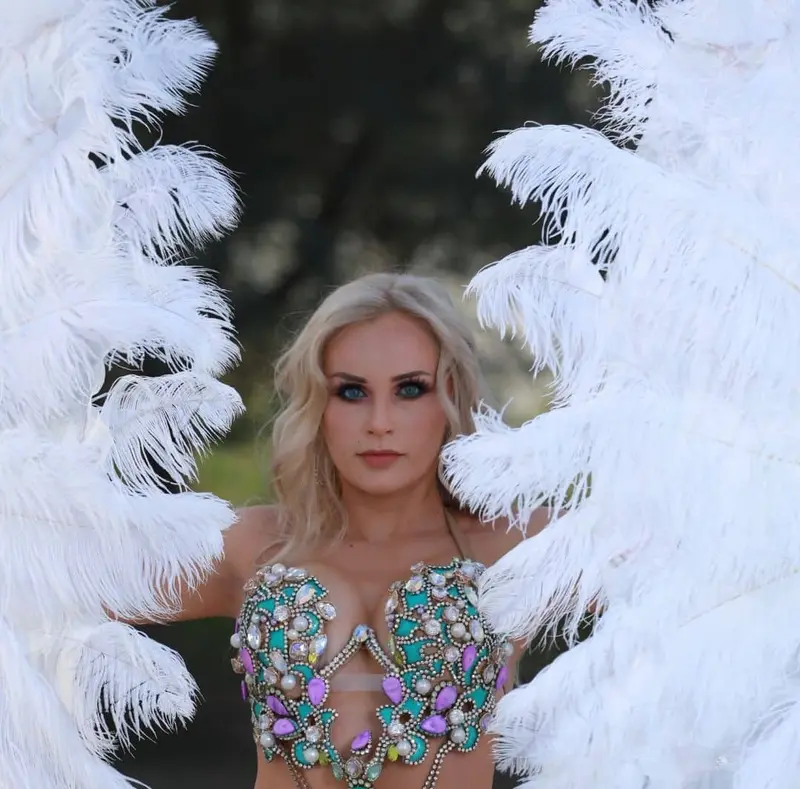 Belly dancer V framed by white feather wings