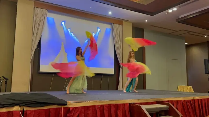 Belly dancers spinning silk fans during a stage show