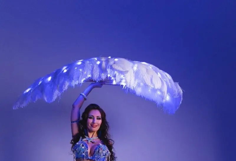 Eve, belly dancer, with a glowing feather fan