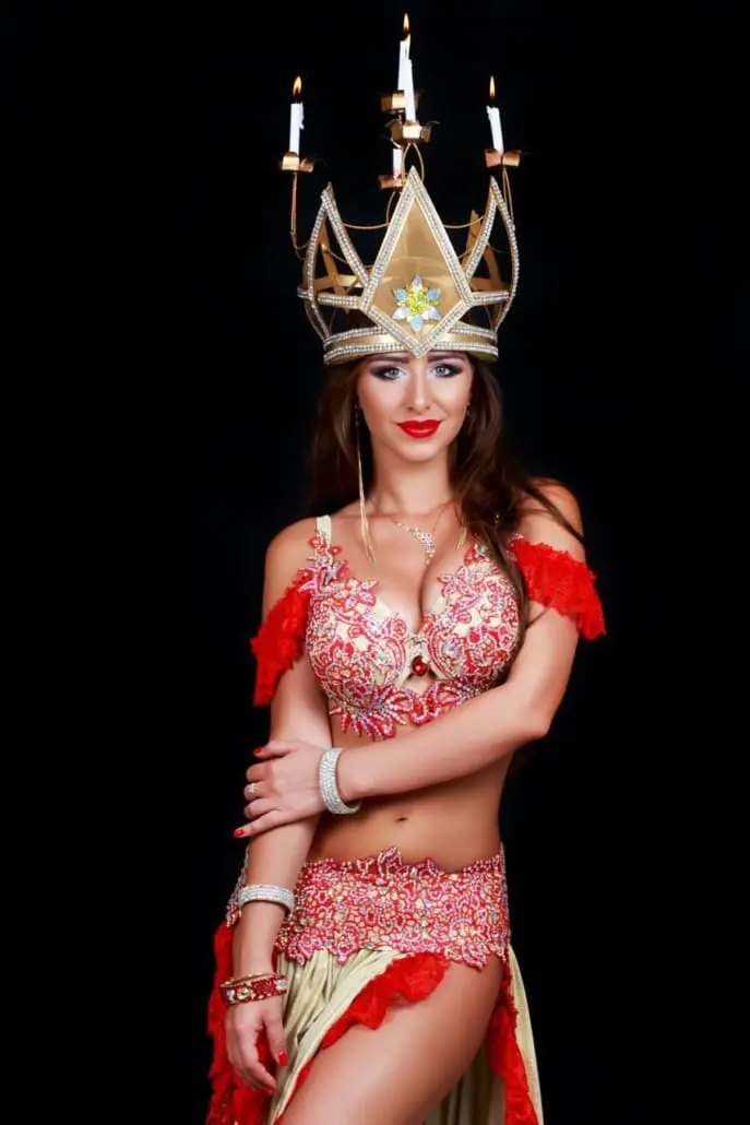 Kate, belly dancer, wearing a crown with candles