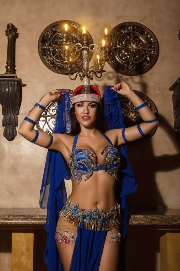 Maria, belly dancer, in a royal blue costume with a jewelled headpiece