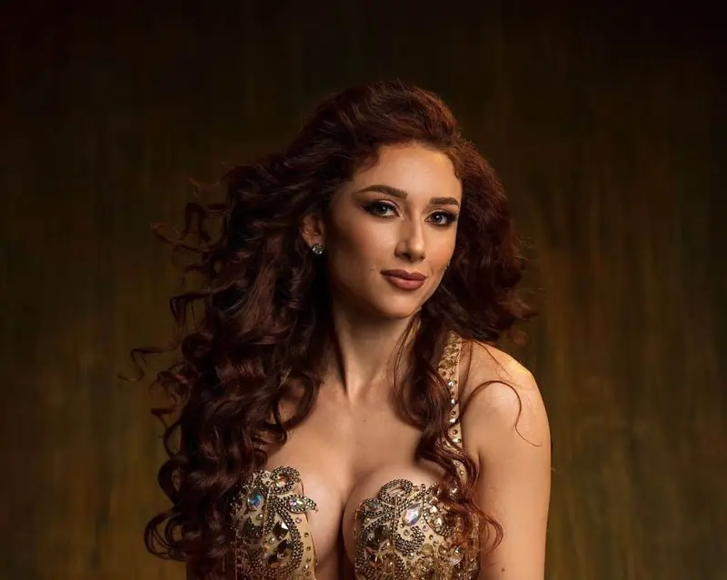 Marika, belly dancer, in a gold costume, studio photo