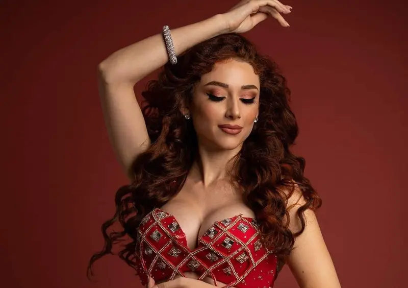 Marika, belly dancer, in a red costume, studio photo