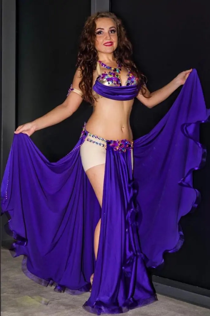 Omira, belly dancer, spreading a purple skirt