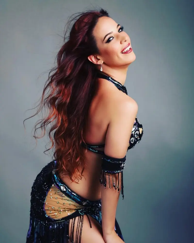 Shaima, belly dancer, in a black fringe costume, studio photo