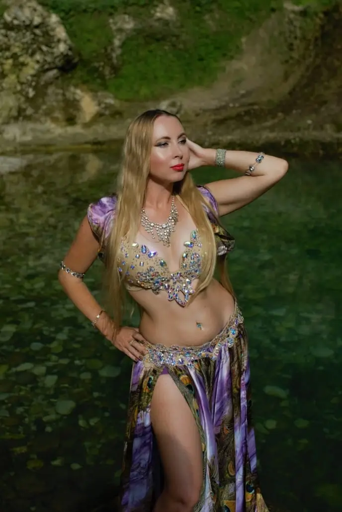 Xena, belly dancer, standing in a rock pool